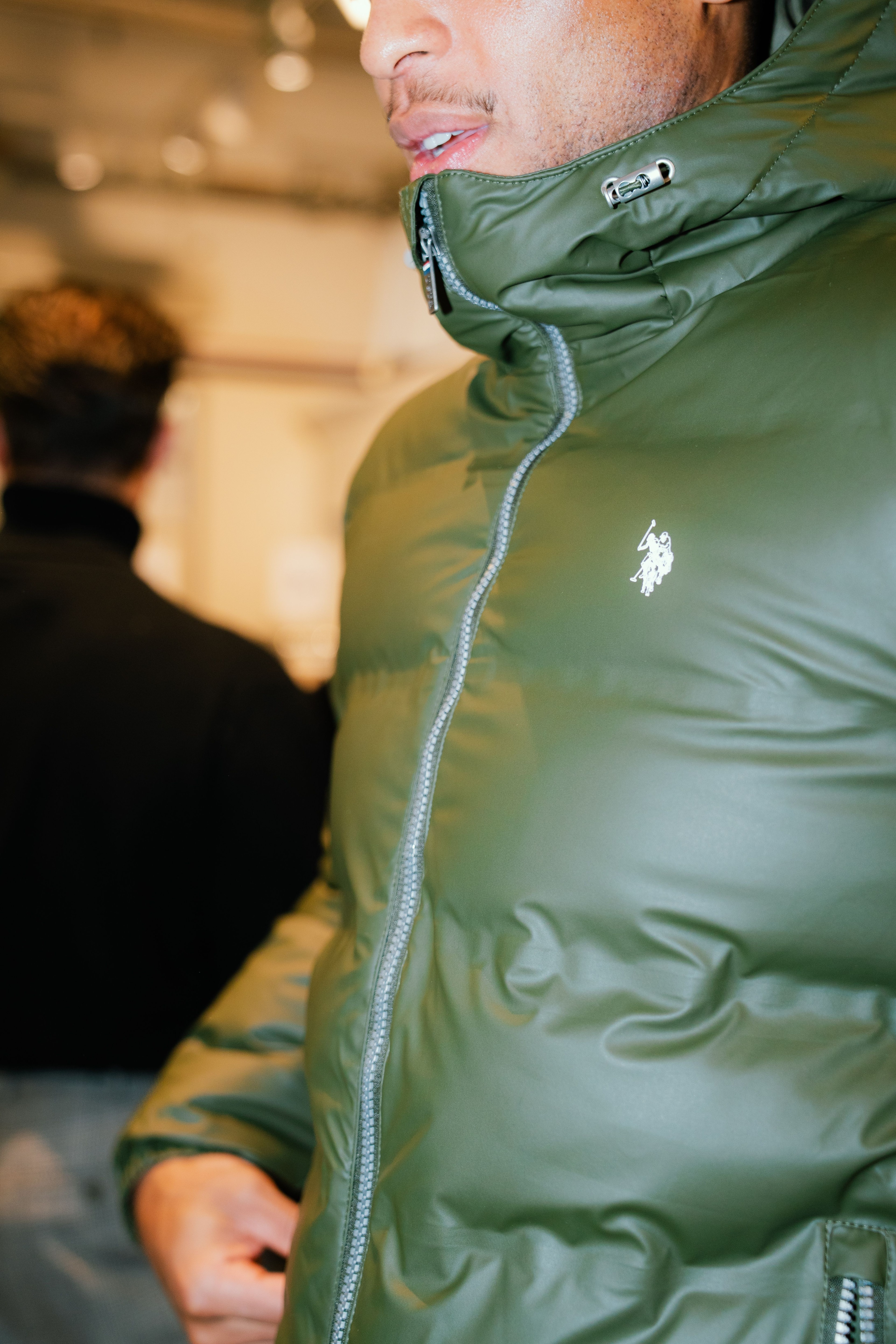 Close-up of a U.S. Polo Assn. logo on a green jacket