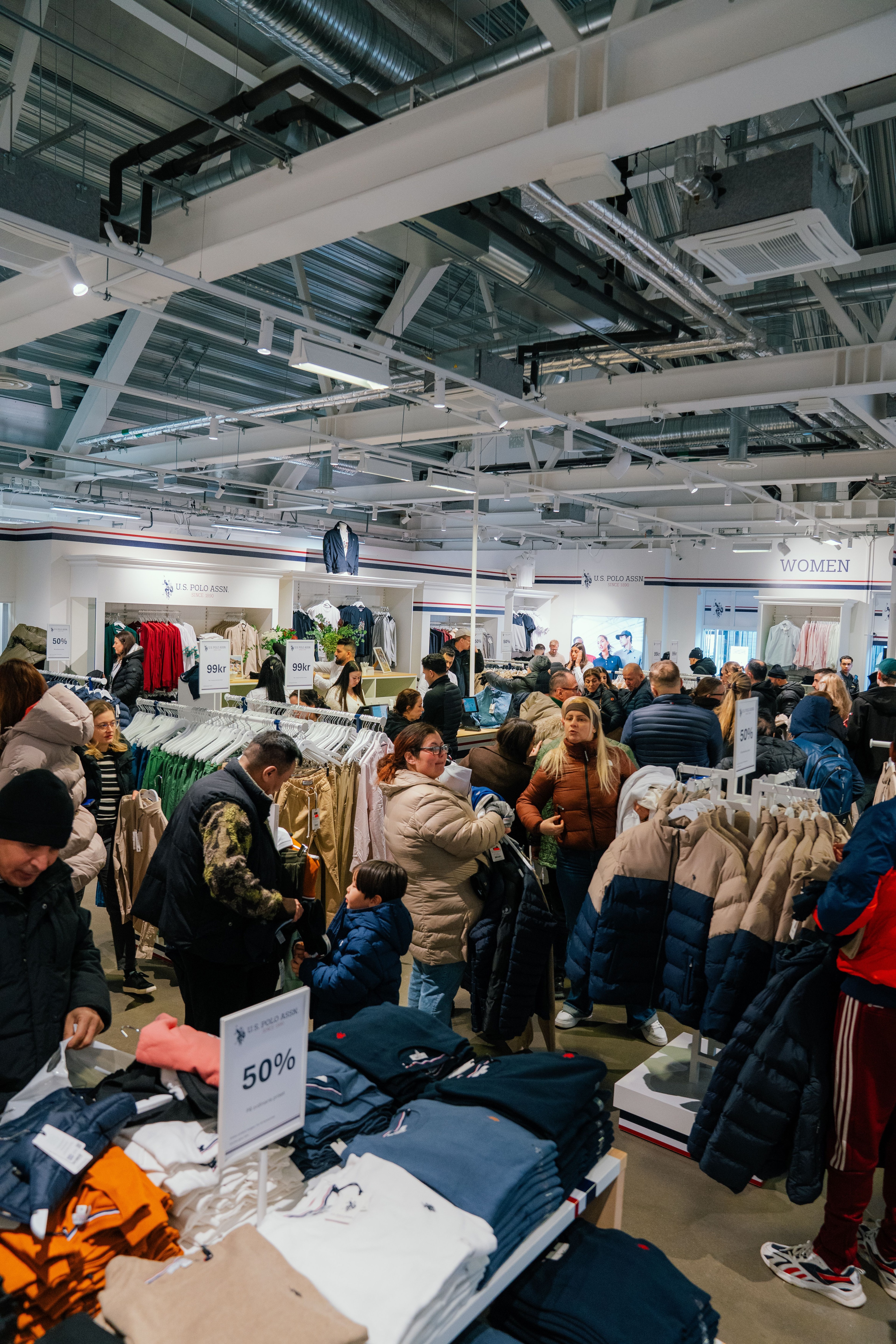 Shoppers browsing the U.S. Polo Assn. outlet store on opening day