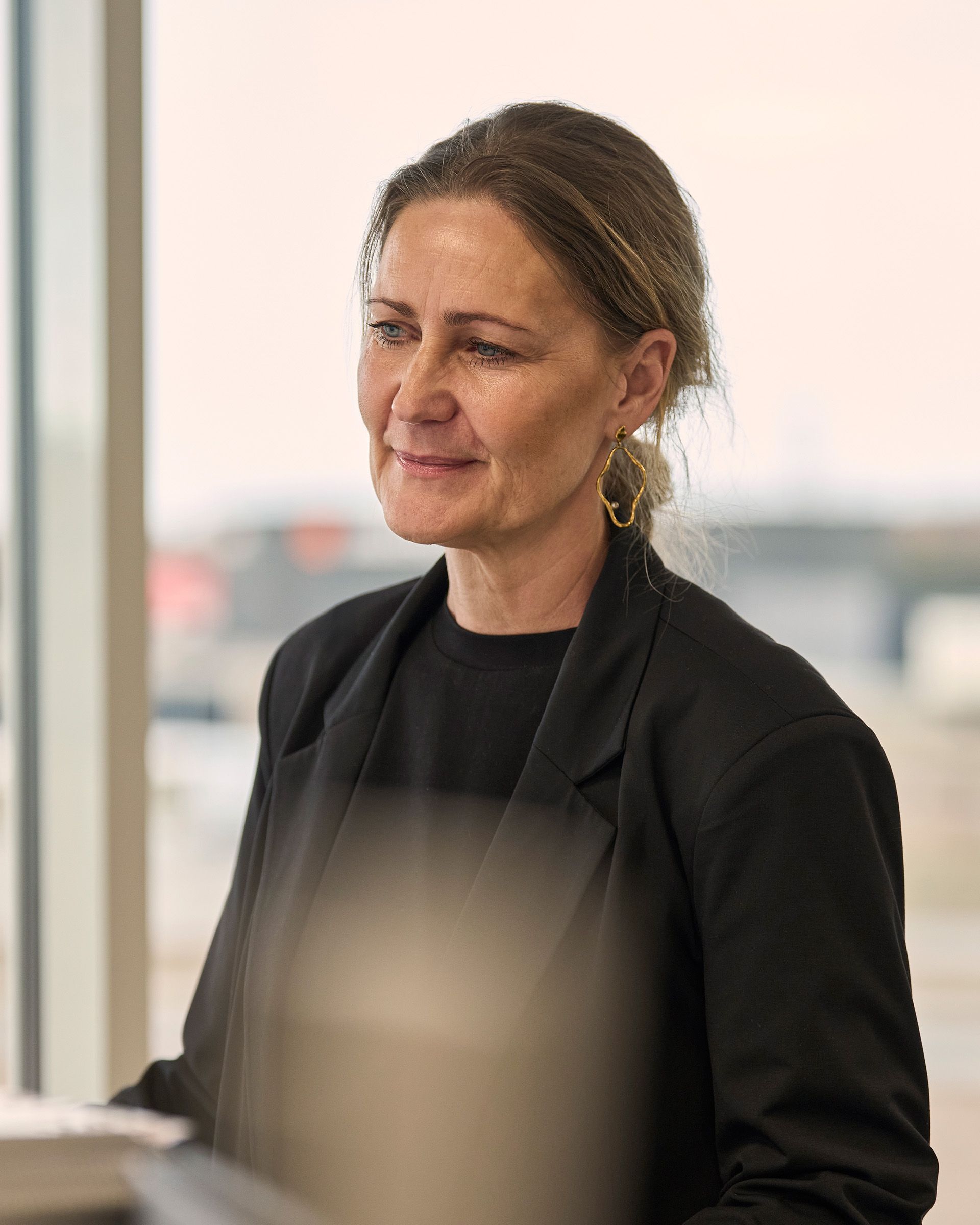 A STARTEX colleague smiling by the window