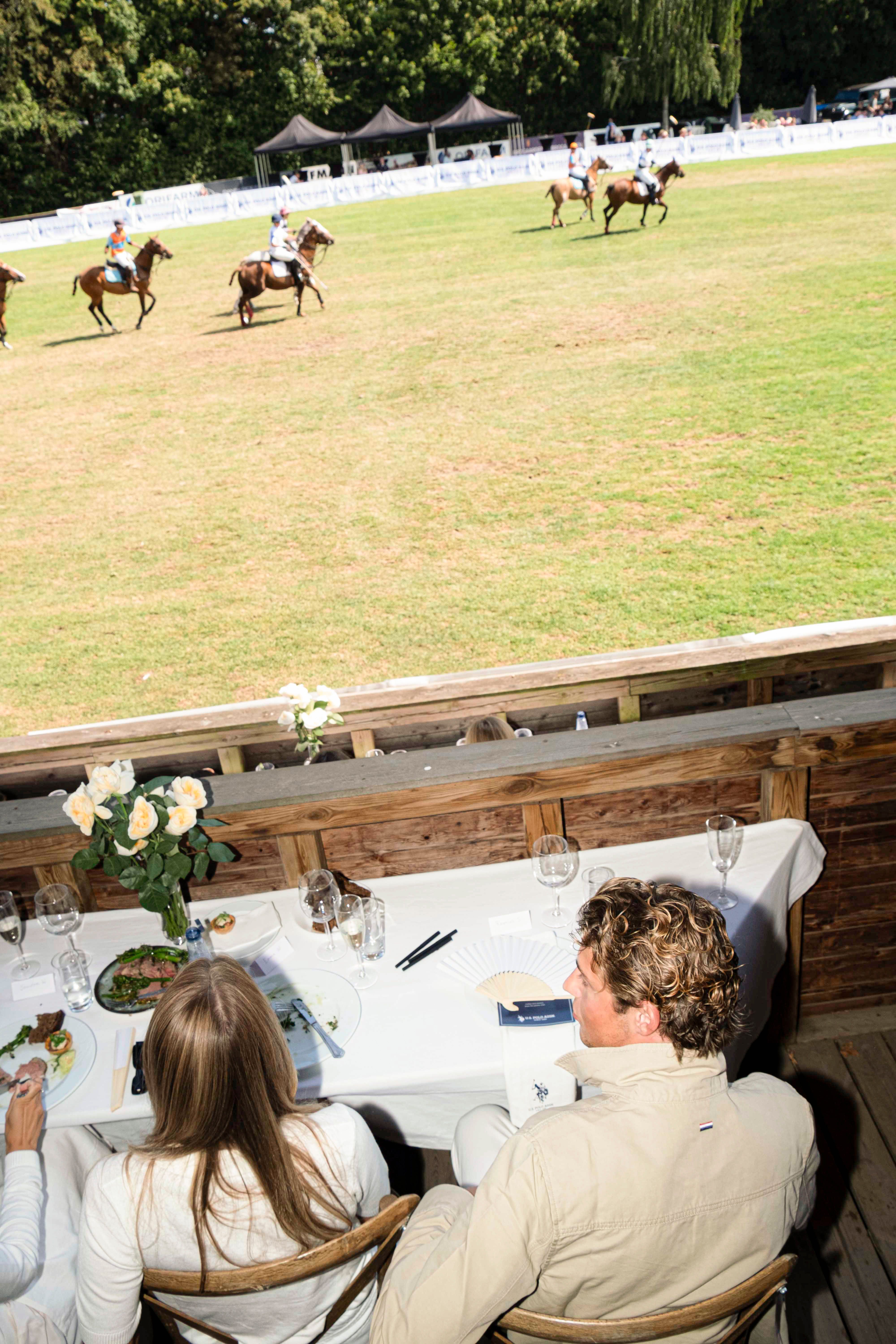 Guests watching the polo match from the STARTEX hospitality tent at Bernstorffsparken