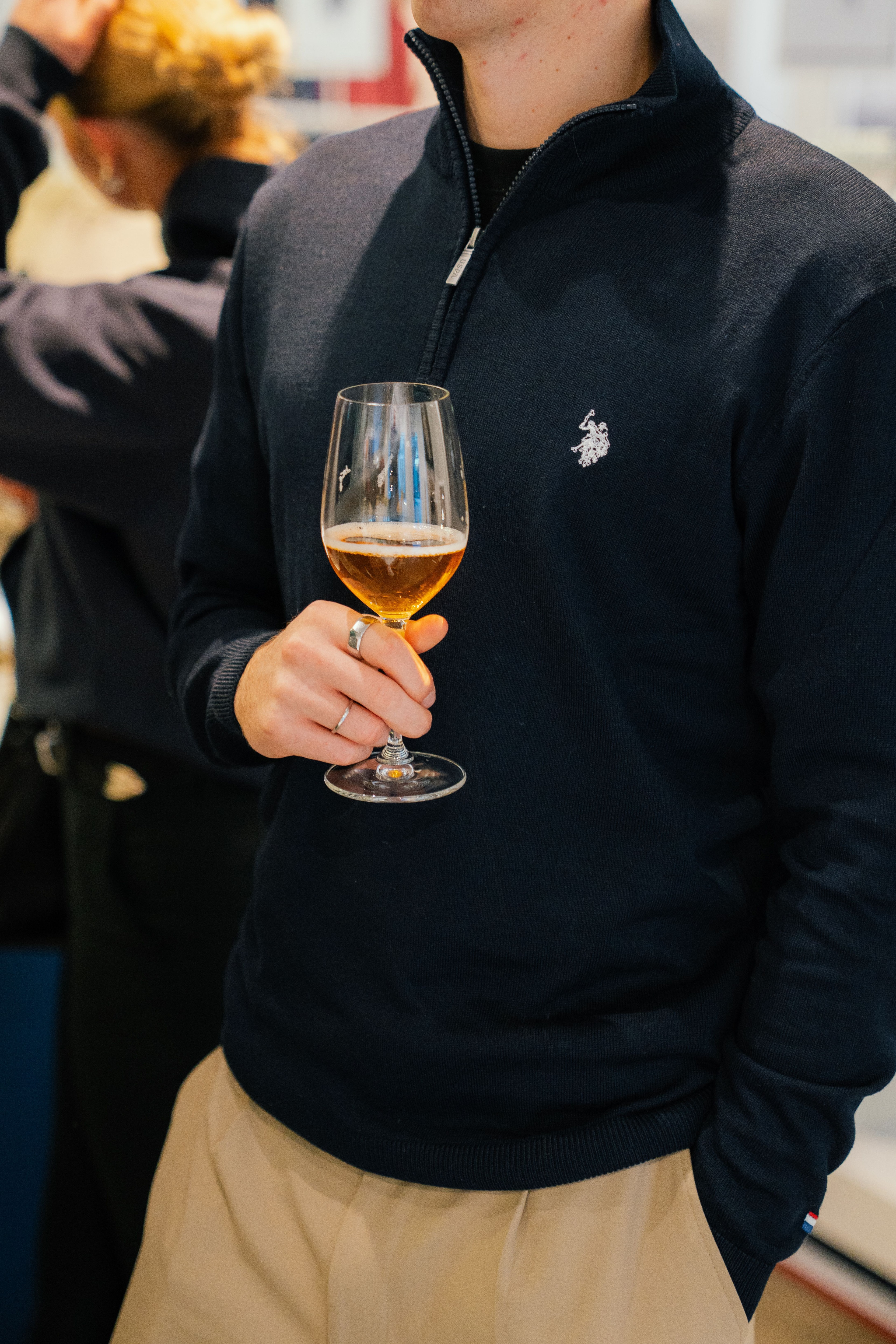 Guest holding a glass of beer at the opening