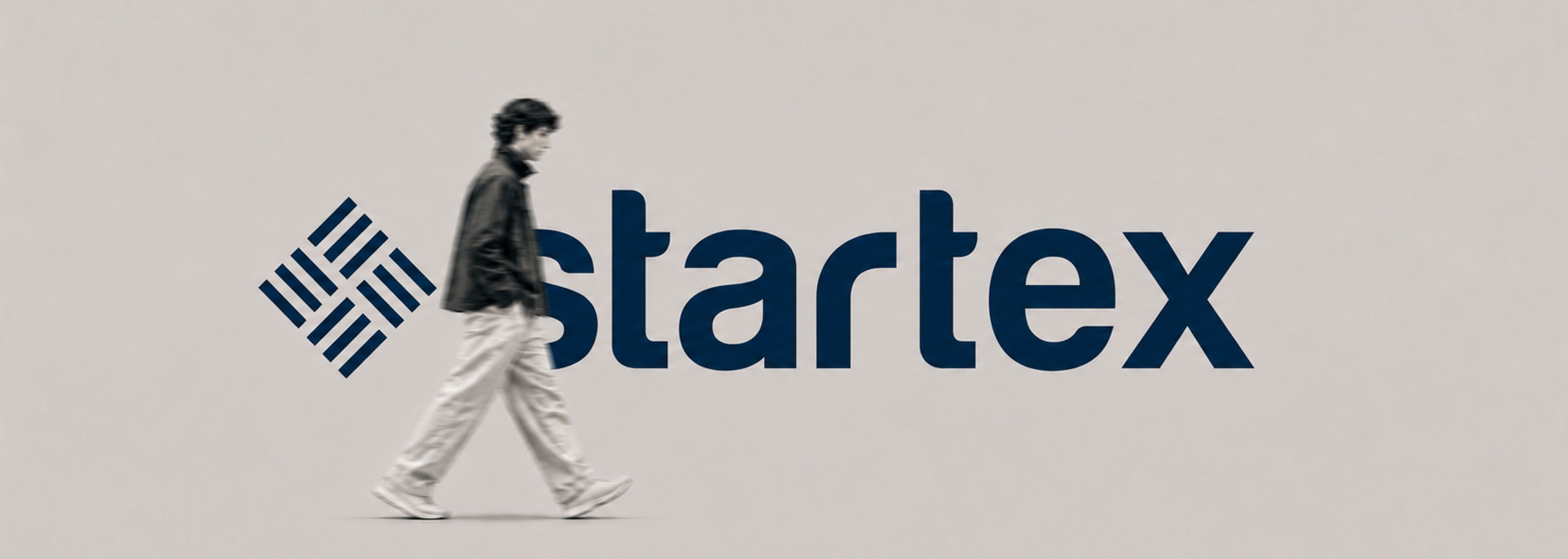 A man walking past the STARTEX wordmark